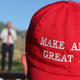 A Romney supporter listens to a speaker as he wears a ‘Make America Great Again’ hat at the Mitt Romney election party on June 26, 2018 in Orem, Utah.